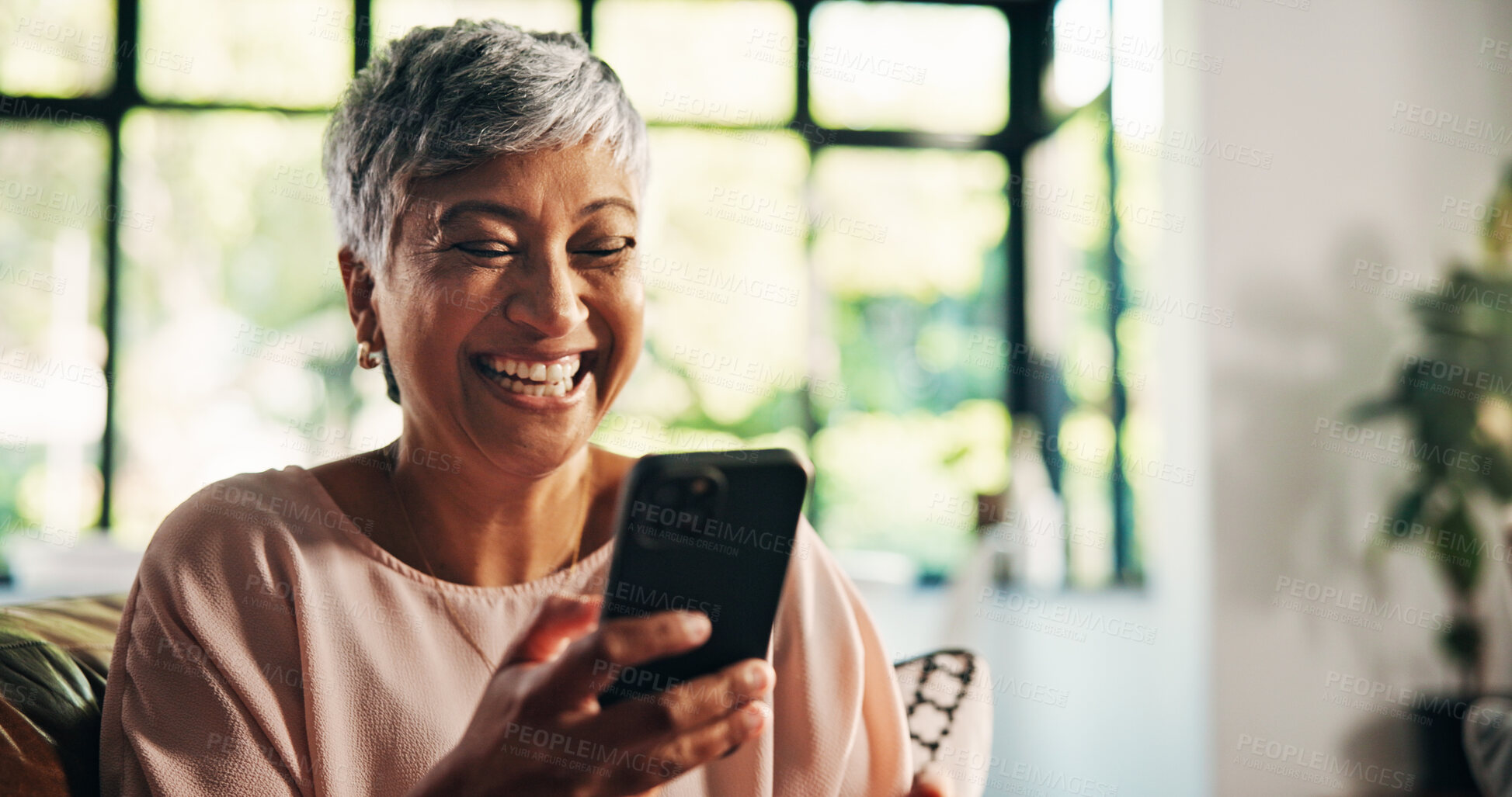 Buy stock photo Phone, relax and smile with senior woman in living room of home for social media browsing on sofa. App, connection and wellness with person in apartment for internet search or typing text message