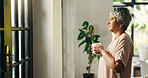 Thinking, senior woman and coffee at window for past memory, nostalgia and morning routine. Lonely, elderly person and reflection with beverage, retirement decision and daydreaming with view at house