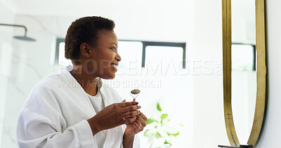 Buy stock photo Jade roller, mirror and happy woman in bathroom for skincare, beauty and facial treatment. Dermatology, home and African person with face tools for cosmetics, grooming and health for morning routine