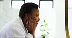 Facial treatment, skincare and woman with cosmetics, beauty and routine for smooth skin or bathroom. Home, black person and dermatology for soft face, moisturizer and self care in morning or grooming