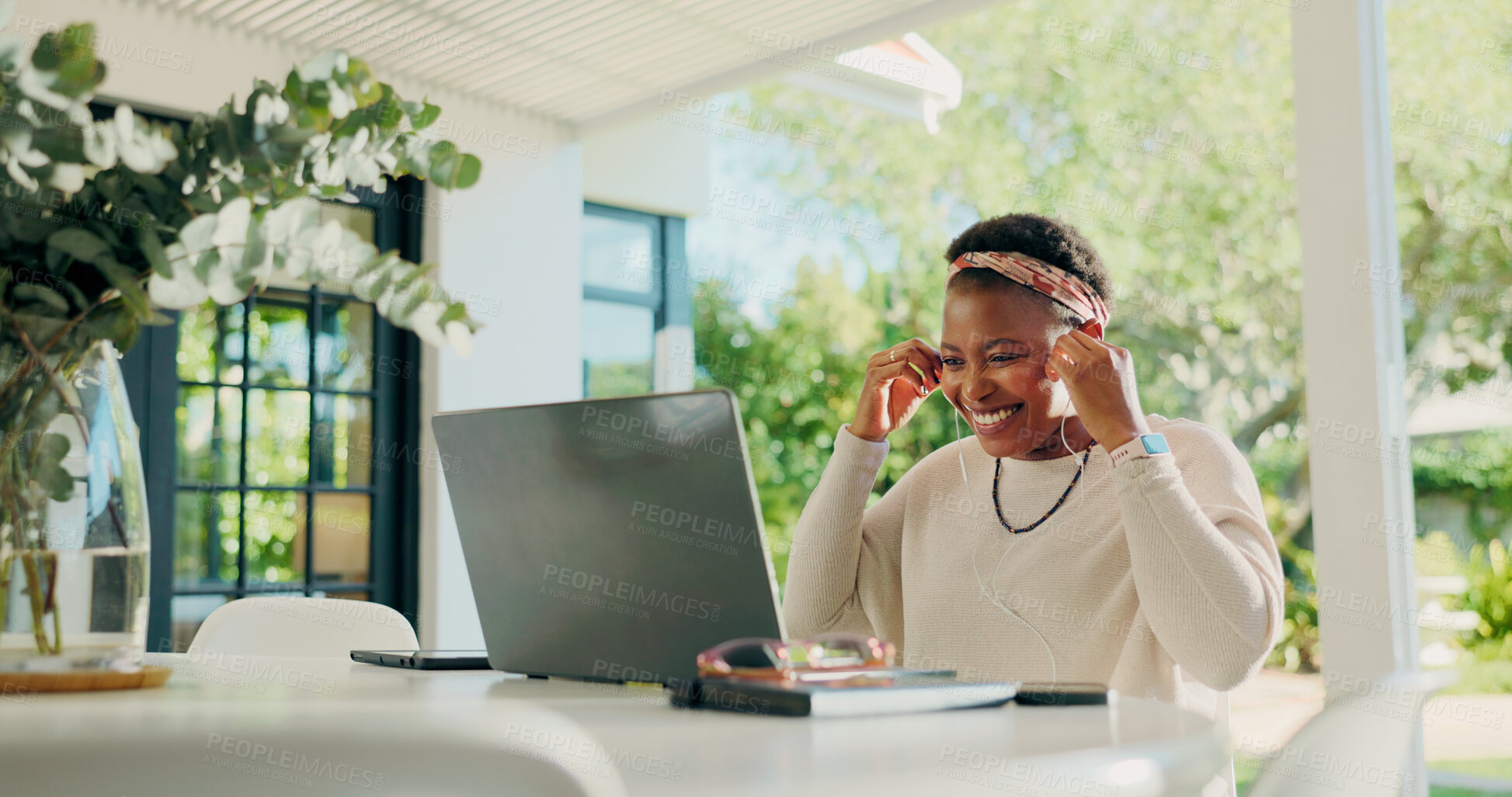 Buy stock photo Black woman, laptop and earphones for video call with remote work from home, happy or contact on web. African person, computer and smile for virtual meeting, discussion and listen at apartment
