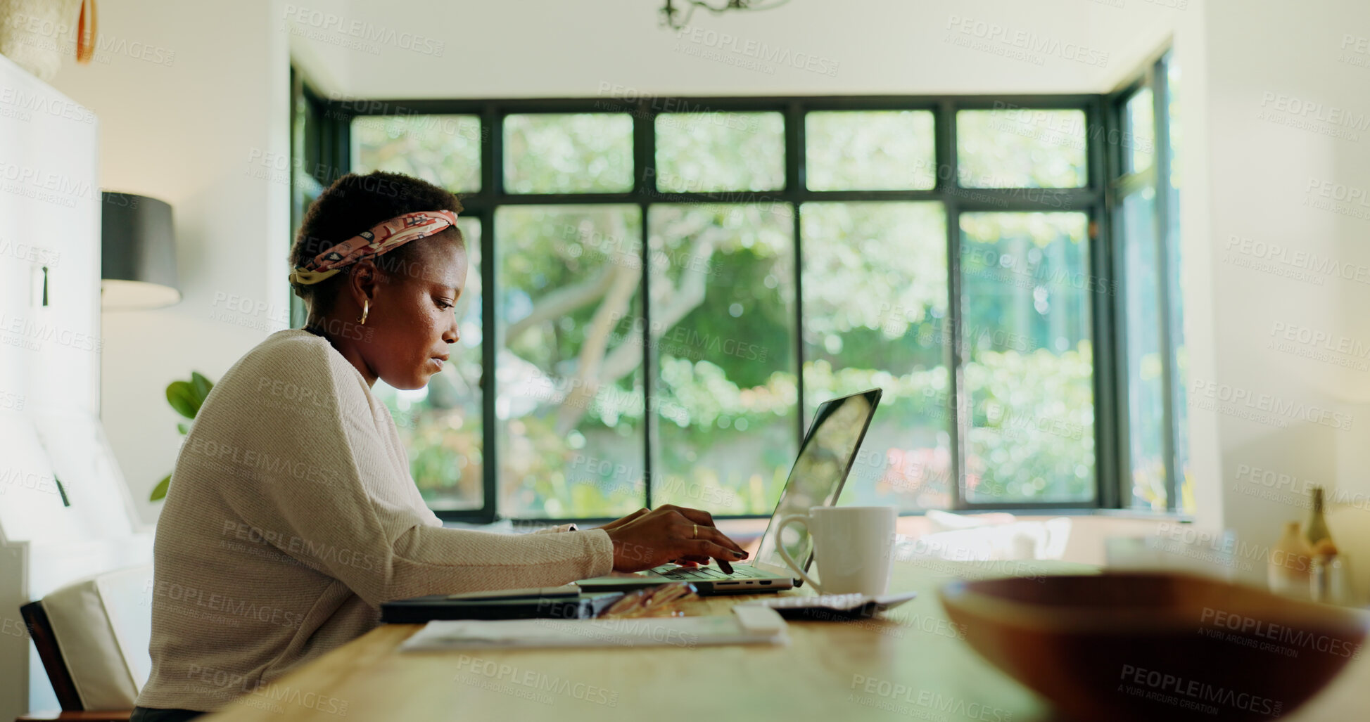 Buy stock photo African woman, typing and laptop at house for remote work, review article and proofreading. Female freelancer, coffee and online with email information, story feedback and news update for publication