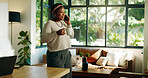 Black woman, phone call and talk in home with coffee, conversation and listen in living room. African person, smile and smartphone with chat, drink and tea cup with discussion in morning at apartment
