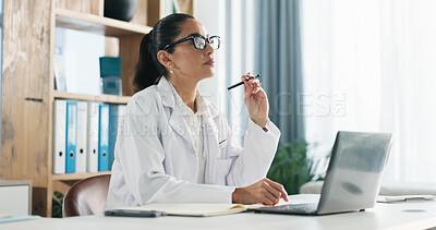 Buy stock photo Thinking, doctor or woman with laptop for research on medical website, study notes or administration in clinic. Paperwork, reading or writing online report in with healthcare professional in office