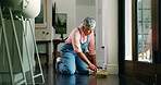 Sweeping, floor and senior woman with brush for hygiene, housekeeping and cleaning service. Domestic, worker and mature person with dust pan, trash scoop and routine for clutter maintenance in home