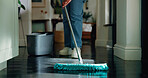 Legs, person and cleaning the floor with mop for dust removal, bacteria prevention or maintenance. Sanitary, cleaner and home disinfection for hygiene, housekeeping or domestic chores for cleanliness