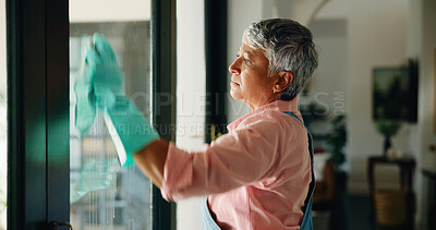 Buy stock photo Cleaning, window and mature woman with cloth for hygiene, housekeeping and maid service. Washing, glass and senior person with shine, detergents and liquid for bacteria, disinfection and dust in home
