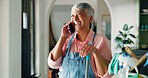 Phone call, cleaning and woman with supplies in home for contact, networking or communication. Housekeeping, cellphone and mature housewife on mobile conversation by sanitizing products in house.