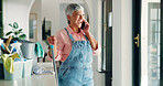 Senior, happy woman and cleaning with phone call for housekeeping or domestic service at home. Female person, maid and cleaner talking with smile on mobile smartphone for hygiene solution at house