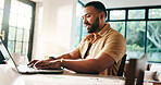 Laptop, freelancer typing and happy man in home office for finance and positive cashflow. Computer, hybrid work and writing email online for accounting, bookkeeping and revenue growth for investment