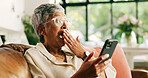 Senior, woman and surprise with phone on sofa for good news, email notification and tax rebate. Shocked, old person and excited with smartphone in home for retirement fund approval, debt free or deal
