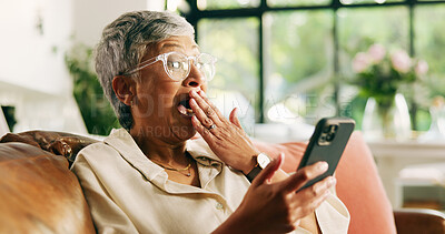 Buy stock photo Senior, woman and surprise with phone on sofa for good news, email notification and tax rebate. Shocked, old person and excited with smartphone in home for retirement fund approval, debt free or deal
