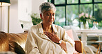 Living room, chest pain and mature woman with heartburn, health risk or angina with medical emergency. Retirement, heart attack and person with cardiovascular disease, cardiac arrest and hypertension