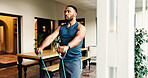 Fitness, man and resistance band to exercise muscle for strength, energy or power at home. Stretching, wellness and strong person with equipment for training, workout arms and bodybuilding for health