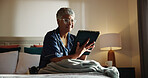 Home, tablet and senior woman in bedroom, internet and online reading for news report. Pensioner, apartment and elderly person with tech, digital app and social media with email, relax and chatting
