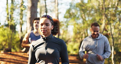 Buy stock photo Marathon, woman and smile in forest for fitness, workout and endurance for health or wellness. Cardio club, running group and jog together for competition, practice and team exercise for training