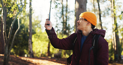 Buy stock photo Forest, frustrated and man with smartphone, signal or lost connection on vacation, online or search. Outdoor, hiker and person with poor reception on mobile, holiday or slow internet in woods or trip