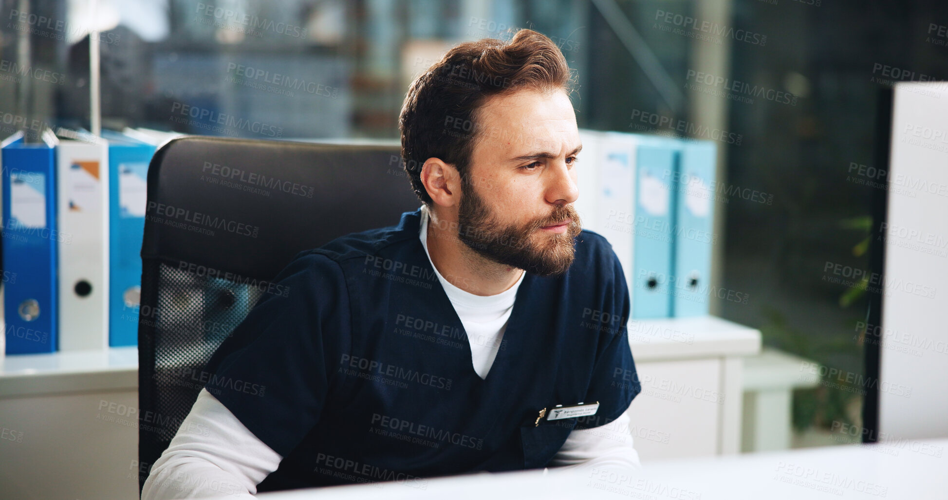 Buy stock photo Healthcare, man and doctor in hospital by computer with research for diagnosis, treatment or surgery planning. Thinking, professional and male surgeon with medical information for problem solving.
