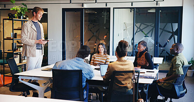 Man, tablet and meeting with people in office for discussion, planning and ideas for headline. Manager, talking and staff listening to article feedback, brainstorming and proposal of online magazine
