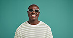Happy, sunglasses and face of black man in studio with trendy style, clothes and outfit. Attitude, fashion and portrait of person with accessories and confidence, pride and smile on blue background