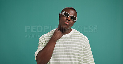 Buy stock photo Black man, fashion and sunglasses with trendy, style and confidence on green studio background. Gen Z, male person portrait or serious African model with accessory, shades or eyewear on mockup space
