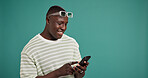 Phone, smile and black man in studio for social media, text or reading fashion blog. Mobile, online chat and happy model on app for news, check forum and play game on background with mockup space