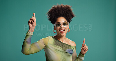 Buy stock photo Dancing, pointing and happy woman in studio with fashion, energy and moves for celebration. African person, excited and gesture for groove, sunglasses or good mood on green background with space