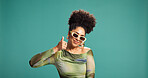 Thumbs up, fashion and happy woman in studio with sunglasses, approval and vote for agreement. African person,  smile and gesture for yes, success or ok on green background with mockup space