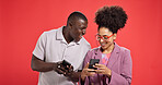 Happy couple, funny or meme with phone in studio for social media or fashion on red background. Online post, laughing or people with smile or mobile app for chat notification, joke and trendy clothes