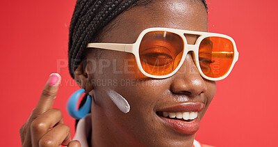 Buy stock photo Black woman, face and cream for skincare, hydration and moisturizer treatment with cosmetics in studio. Aesthetic, person and model with product for facial lotion, glow or wellness on red background