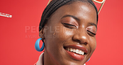 Buy stock photo Black woman, face and serum for skincare, hydration and collagen treatment with cosmetics in studio. Smile, person and model with pipette for facial oil, vitamin c or wellness on red background