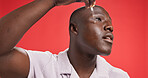 Black man, face and serum for skincare, hydration and collagen treatment with cosmetics in studio. Smile, person and model with pipette for facial oil, vitamin c or wellness on red background