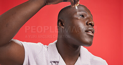 Buy stock photo Black man, face and serum for skincare, hydration and collagen treatment with cosmetics in studio. Smile, person and model with pipette for facial oil, vitamin c or wellness on red background