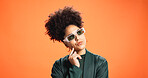 Sunglasses, thinking and woman in studio for fashion, reflection or solution on orange background. African person, thoughts and problem solving with idea, wonder or decision for style on mockup space