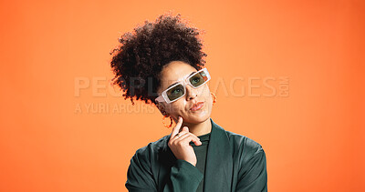 Buy stock photo Sunglasses, thinking and woman in studio for fashion, reflection or solution on orange background. African person, thoughts and problem solving with idea, wonder or decision for style on mockup space