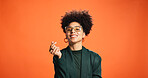 Heart, happy and portrait of woman in studio for love, support and gratitude on orange background. Fashion, smile and person with emoji, gesture and fingers for kindness, thank you and affection