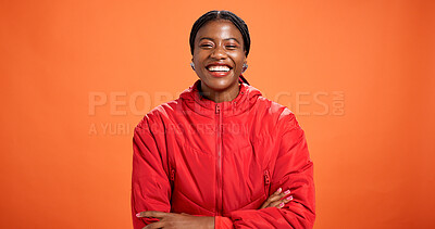Buy stock photo Fashion, confidence and portrait of black woman in studio with trendy clothes, outfit and winter style. Crossed arms, mockup space and person with cool jacket, pride and smile on orange background