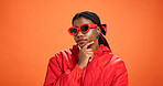 Sunglasses, thinking and black woman in studio for fashion, vision or gen z style. African person, shades or thoughts for reflection, mindset or decision for cool outfit on orange background space