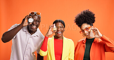 Buy stock photo People, happy and products in studio for skincare, comparison or choice for dermatology. African friends, laugh or lotion container on orange background for cosmetic opinion, serum or beauty portrait