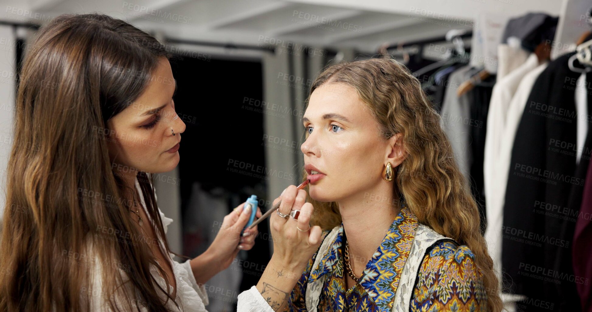 Buy stock photo Woman, model and backstage with makeup artist, lipstick application and makeover process. People, cosmetics and getting ready for photoshoot, beauty touch up and preparation for production in studio