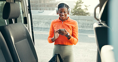 Buy stock photo Runner, phone and car with black woman and headphones for fitness playlist, health and travel. Marathon, workout podcast and streaming with person in city for training songs, sports and drive