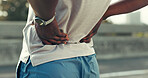 Fitness, workout and man in city with back pain, injury or accident with running or training. Sports, medical emergency and male athlete with muscle sprain, inflammation or bruise for cardio exercise