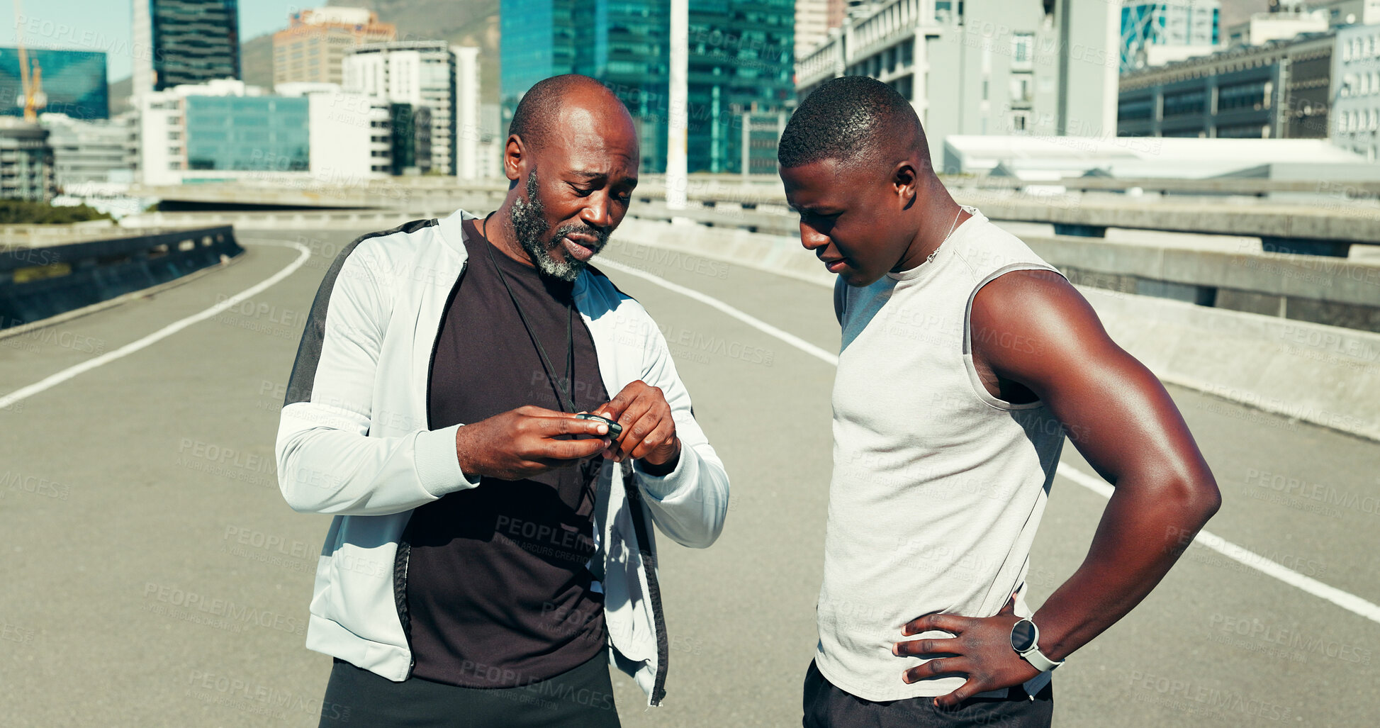 Buy stock photo Fitness, athlete and personal trainer with stopwatch in city for running time, progress and speed. Bridge, black people and instructor with stats for performance, workout pace and monitor heart rate