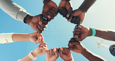 Buy stock photo Circle, group and fist bump for sports, celebration or collaboration for fitness, hands and outdoor. Blue sky, team and gesture for agreement, low angle and community with support, unity and success