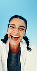 Below, fitness and portrait of woman on blue sky for running, exercise and workout outdoor. Happy, laughing and face of person with smile for marathon training, sports and challenge for endurance