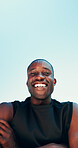 Below, fitness and portrait of happy black man on blue sky for running, exercise and workout. Outdoor, crossed arms and person with smile for marathon training, sports and challenge for endurance