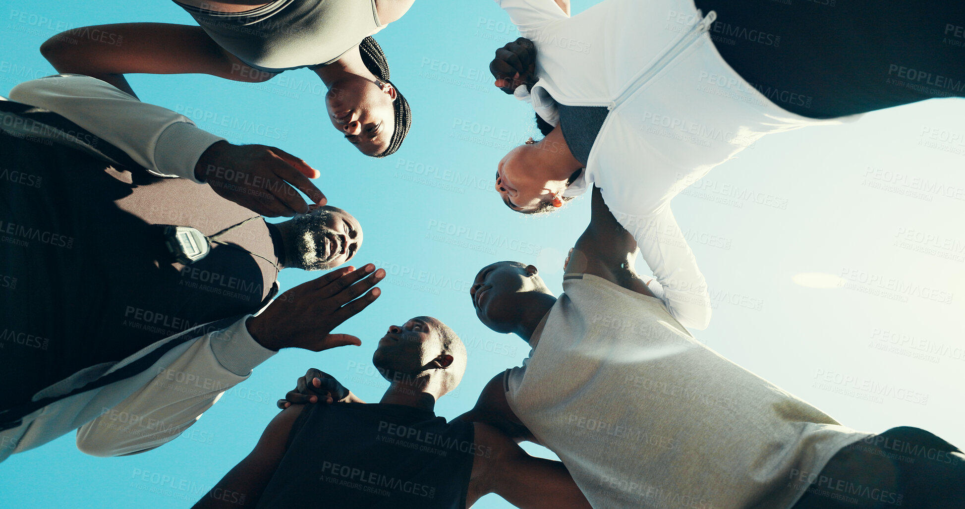 Buy stock photo Huddle, running and coaching with friends in city for support, fitness club or motivation. Sports challenge, exercise and personal trainer with low angle of people for wellness, training and marathon