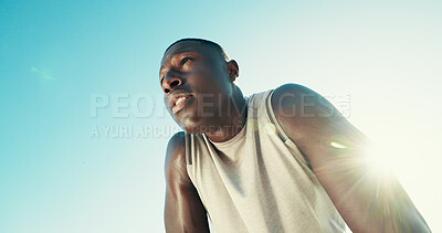 Buy stock photo Fitness, tired and black man rest outdoor for health, wellness or exhausted with intense cardio. Runner, fatigue and relax on break by blue sky for exercise, recovery or flare with space in low angle