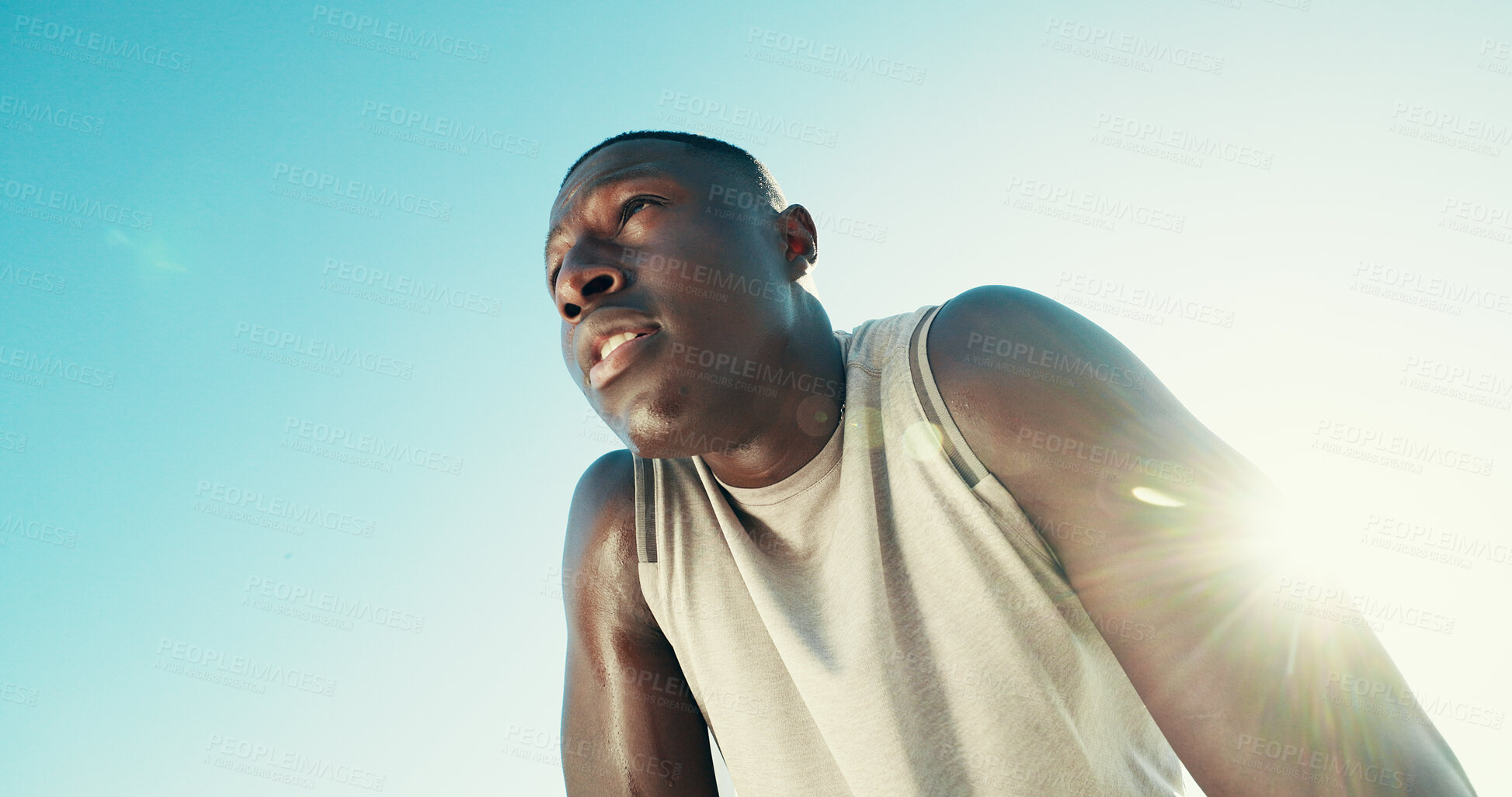 Buy stock photo Fitness, tired and black man rest outdoor for health, wellness or exhausted with intense cardio. Runner, fatigue and relax on break by blue sky for exercise, recovery or flare with space in low angle