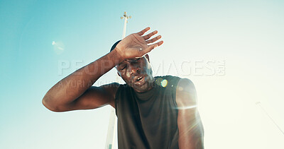 Buy stock photo Fatigue, fitness and black man by blue sky for running, workout or training for marathon with break. Tired, sweating and African male athlete with rest for outdoor cardio exercise from below.